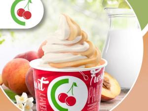 frozen yogurt in a branded cup with peaches and cream 