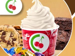branded cup of yogurt surrounded by cookies and candy